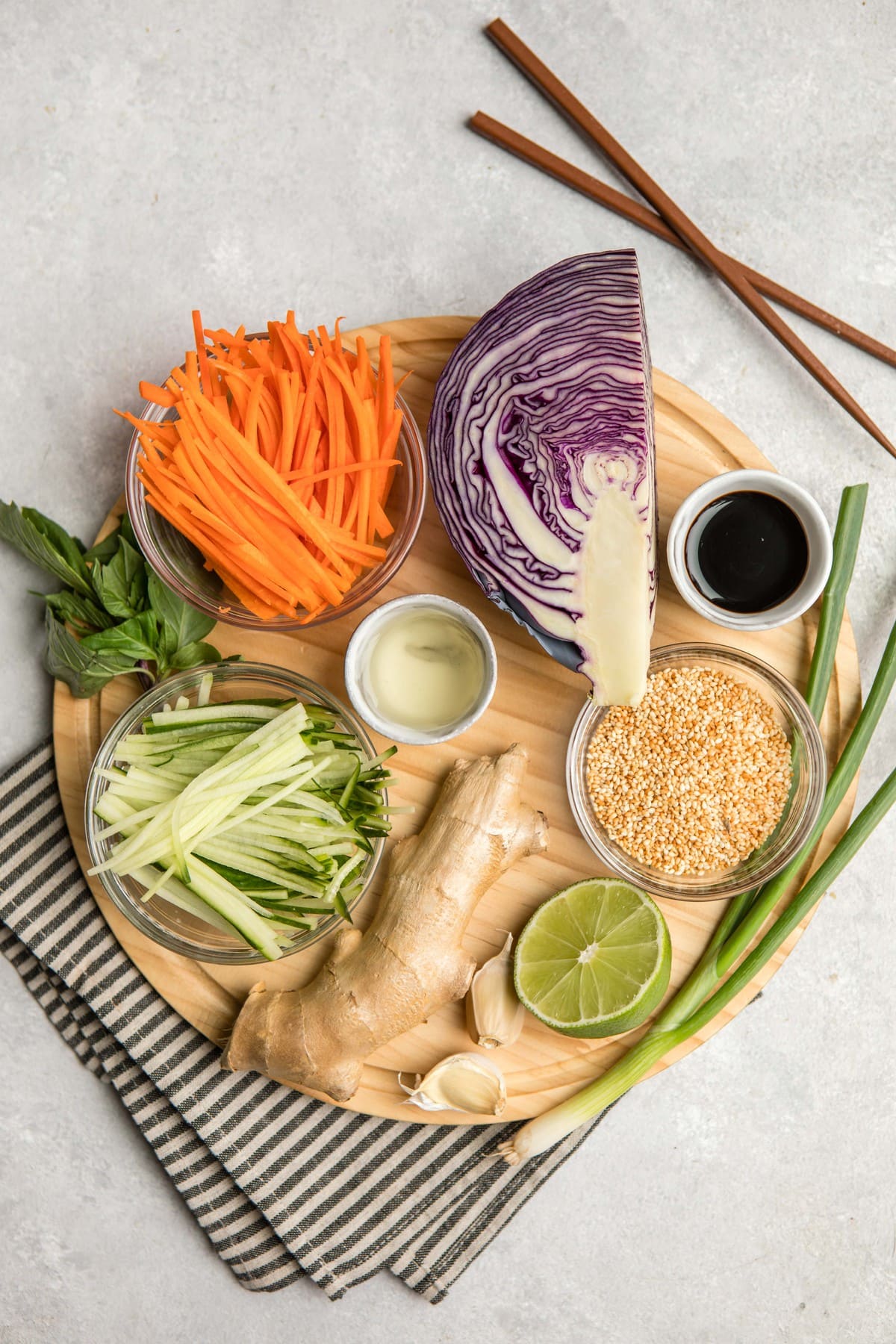 ingredients for crunchy asian slaw on round wood serving board