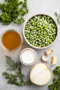 ingredients for pea soup on gray textured background