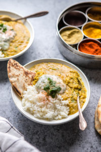 instant pot dal with rice, naan, and raita in white bowl