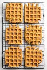 six vegan blender waffles on black cooling rack