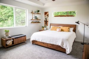 master bedroom decorated with wood furniture and white and yellow accents