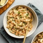 dill pickle pasta salad in white bowl with navy napkin
