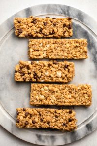 sliced granola bars on round marble cutting board