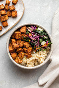 crispy tempeh, kale salad, and rice in bowl