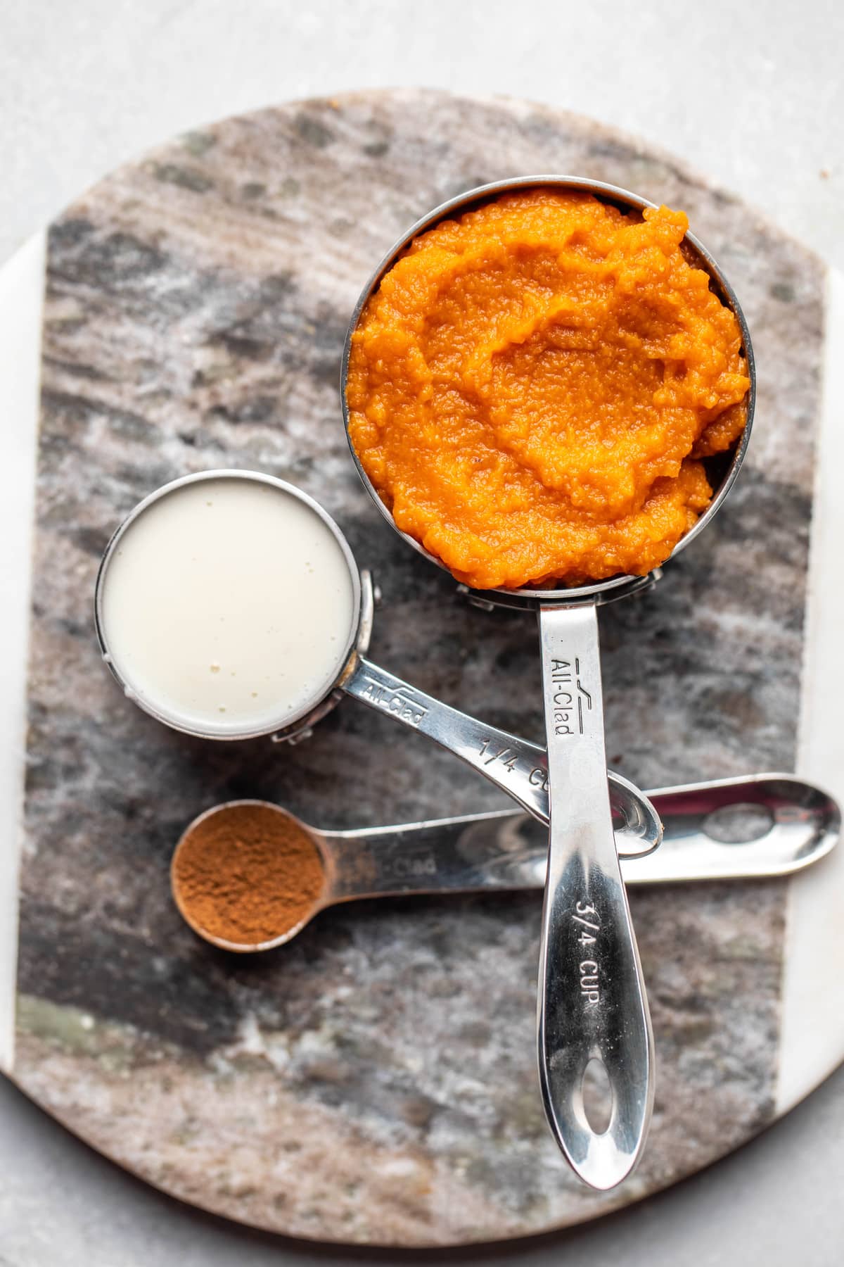 ingredients for pumpkin butter on round gray serving tray