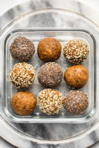 rolled golden milk energy bites in hemp and chia seeds in glass container