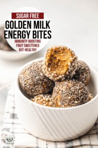 golden milk energy bites in white bowl with bite taken out of top bite