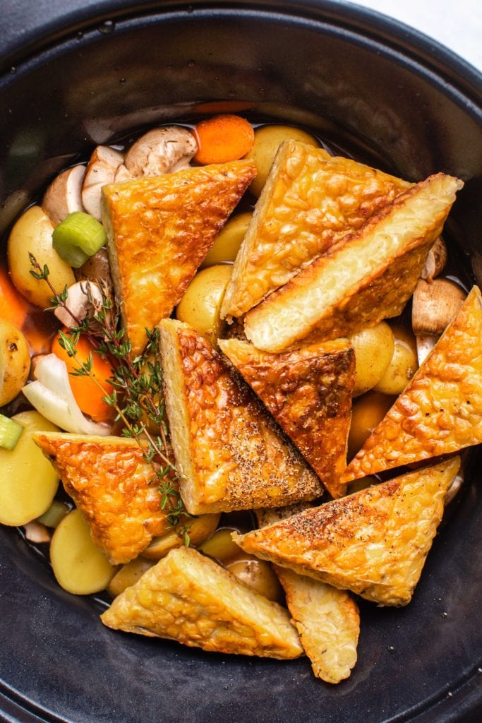 close up picture of tempeh and vegetables for pot roast in slow cooker before cooking