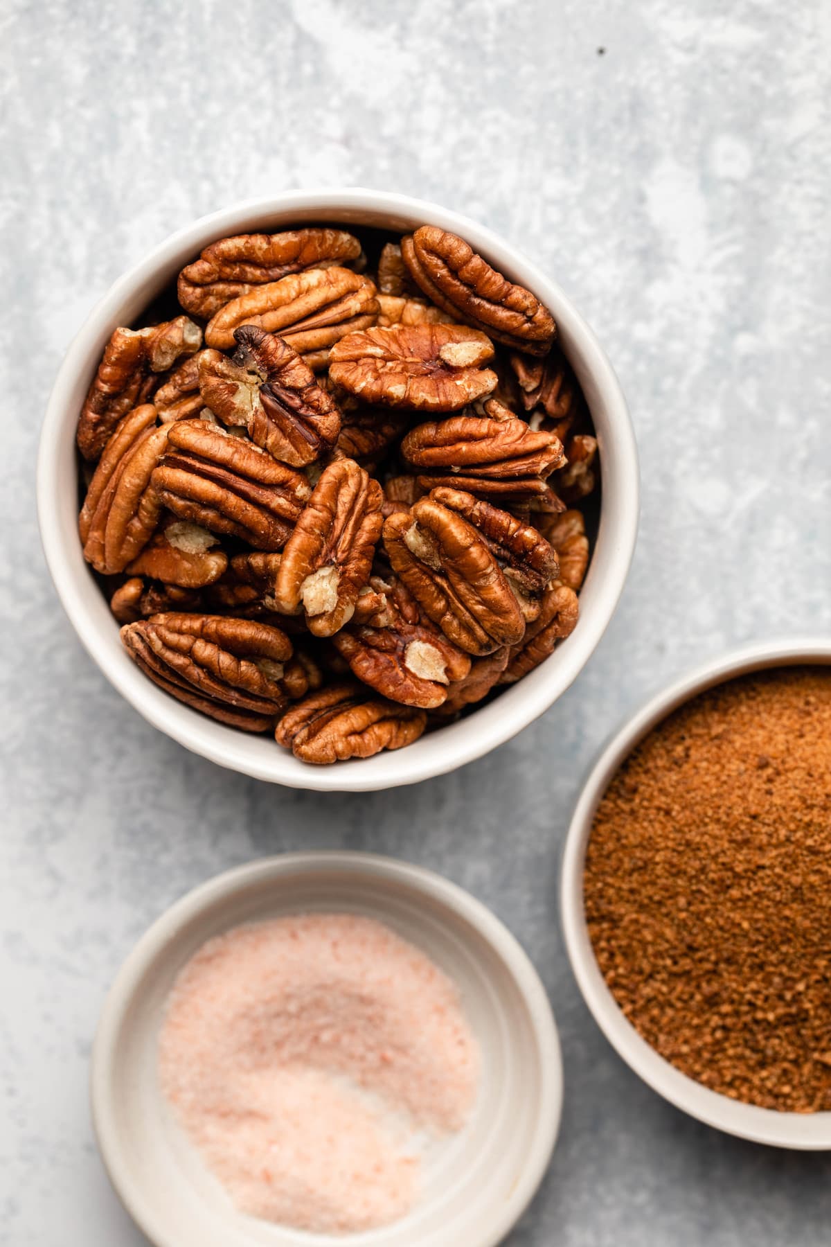 pecans, coconut sugar, and salt in small white bowls