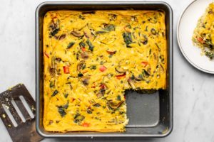 vegan breakfast casserole in gray baking tray on marble background