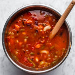 instant pot base filled with cooked minestrone soup on marble background