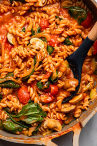 close up photo of cooked one pot pasta with wooden spoon