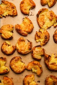 crispy smashed potatoes on baking tray after baking in the oven