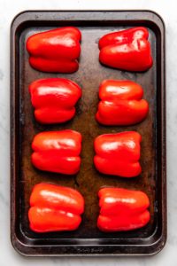 uncooked bell peppers on baking tray