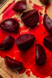 peeled beets on wooden cutting board