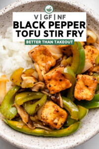 close up photo of bowl of black pepper tofu stir fry with white rice