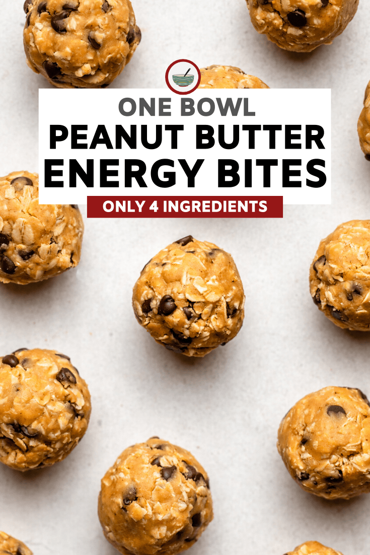 peanut butter energy bites spread out on white stone background