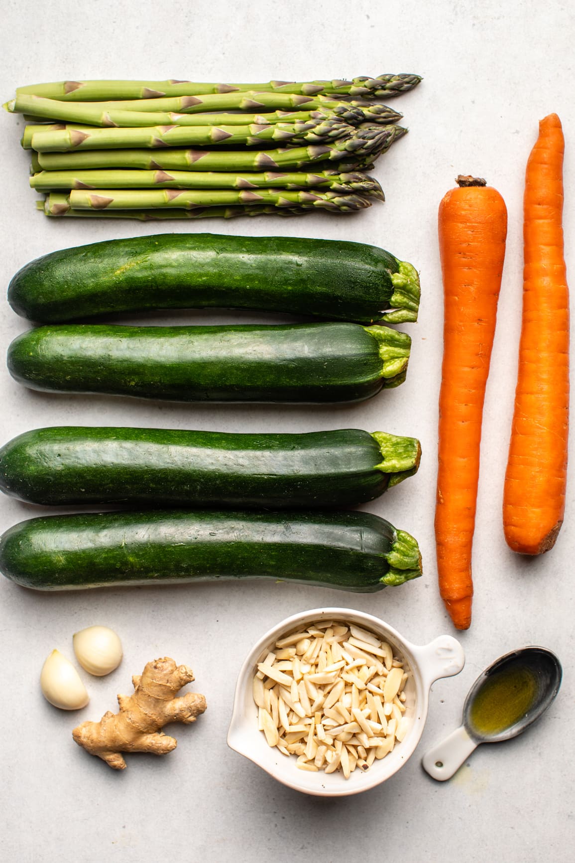 ingredients for stuffed zucchini arranged on white marble background