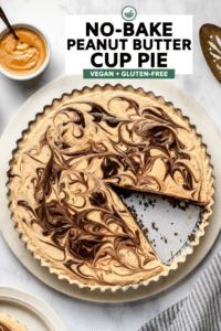 no bake peanut butter cup pie with slice taken out of it on marble background