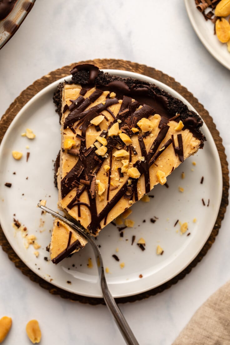 Slice of peanut butter cup pie with fork cutting through it