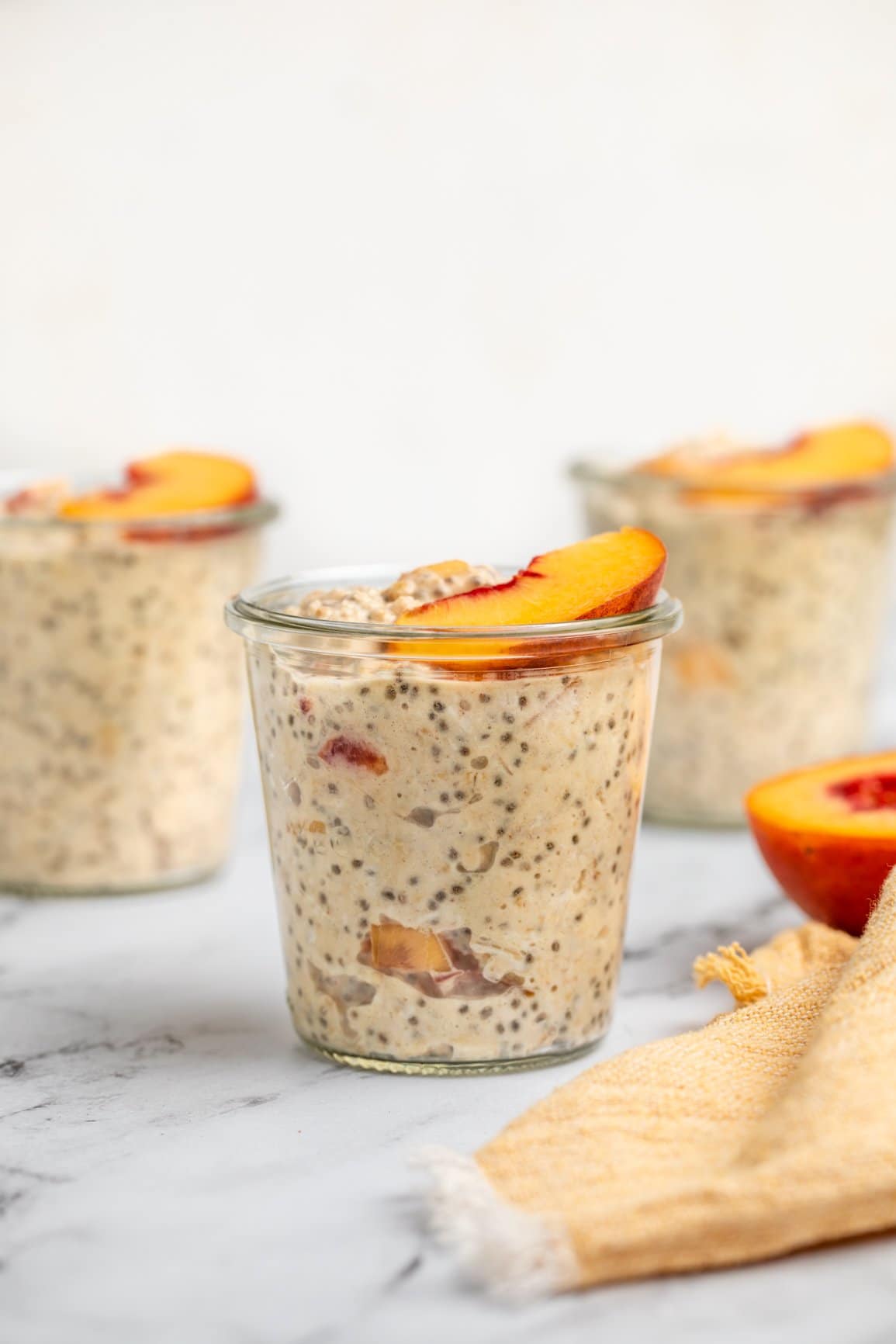 3 jars of peaches & cream overnight oatmeal topped with fresh peach