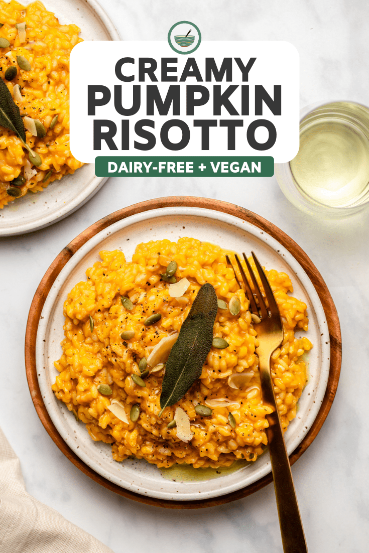 pumpkin risotto on white plate topped with oil, pumpkin seeds, and fried sage
