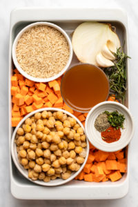 ingredients for sweet potato rosemary casserole arranged inside of casserole dish in small white dishes