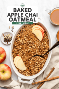 large white baking dish of apple chai baked oatmeal topped with fresh apples