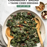 This simple vegan Kale Salad is studded with dried cranberries, crunchy pecans, and shallot. The simple Tahini Cider Dressing takes it to the top!