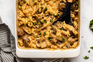 No Boil baked vegan mushroom stroganoff in white casserole dish topped with fresh parsley