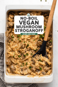 no boil baked vegan mushroom casserole topped with fresh parsley and wooden serving spoon