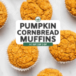 pumpkin cornbread muffins in white paper liners on marble background