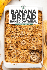 sliced banana bread oatmeal in white baking dish with vintage serving spoon