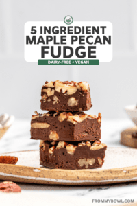 stack of maple pecan fudge on white speckled plate on marble countertop