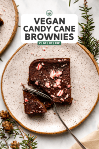candy cane brownie on small white plate with fork cutting into it