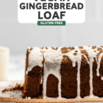 side shot of sliced gingerbread loaf with icing drizzled over the top of it