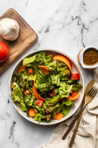salad with lettuce, tomato, and carrot tossed in balsamic vinaigrette