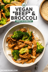 beef and broccoli over rice in white bowl on marble countertop