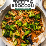 large pan of beef & broccoli with wooden spatula scooping a serving portion out of it