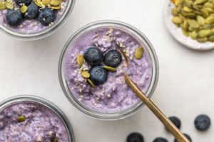 glass jar of blueberry overnight oats topped with fresh blueberries and hemp hearts
