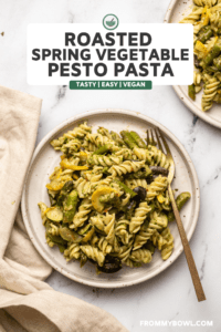 roasted vegetable pesto pasta on two plates on marble background