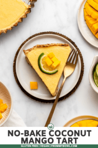Slice of mango tart topped with lime slice on marble background