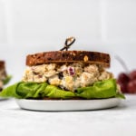 Chickpea salad sandwich on toasted bread with leafy lettuce on marble background