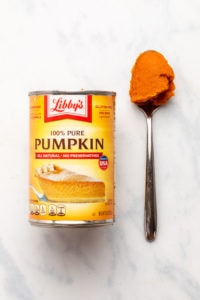 Can of Libby's pumpkin puree next to spoon with puree on it