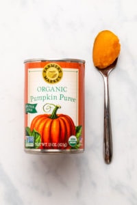 Can of Farmer's Market pumpkin puree next to spoon with puree on it