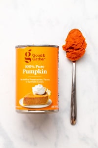 Can of Target's Good & Gather pumpkin puree next to spoon with puree on it