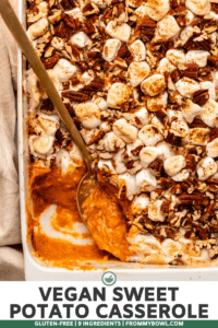 Close-up photo of baked sweet potato casserole with gold spoon in baking dish scooping some of the casserole out