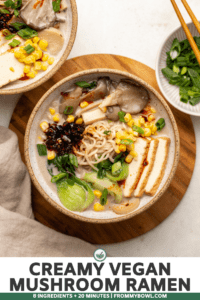 Two bowls of vegan mushroom ramen topped with tofu and corn on stone countertop