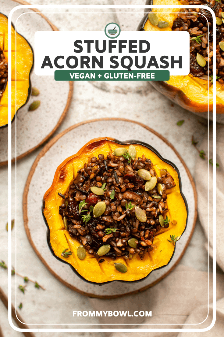 Stuffed Acorn Squash on small speckled white plate, with two cooked squashes off to the side as well