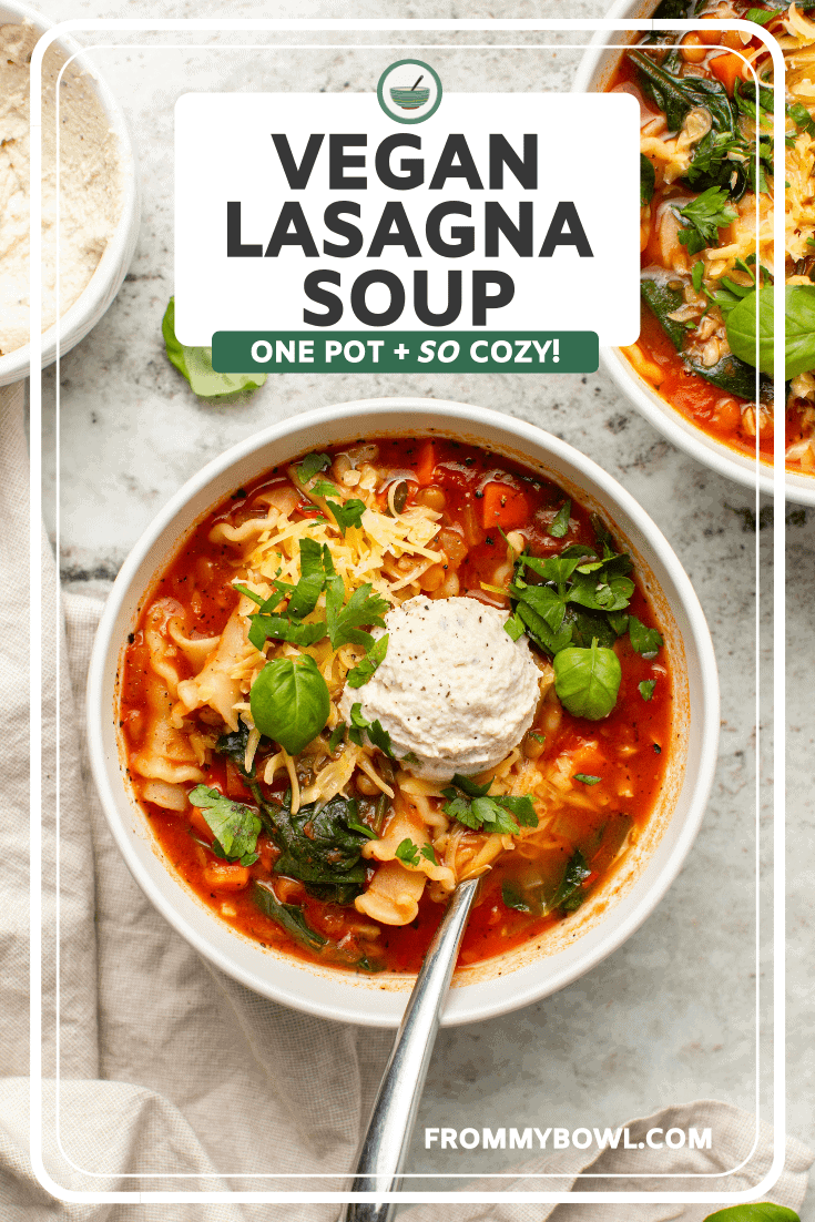 photo of vegan lasagna soup topped with ricotta cheese, and fresh herbs on stone countertop